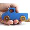 Handmade wooden toy pickup truck painted in baby blue with metallic sapphire blue trim. The truck features non-marring amber shellac wheels and is part of my Play Pal Collection. A close-up shot of the toy truck on a white background. Made to Order.